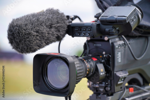 video camera on a tripod , playback, objective, tripod, optic, technology, telephoto lens, news, hd, system, transmitter, accumulator, set, interview, shooting