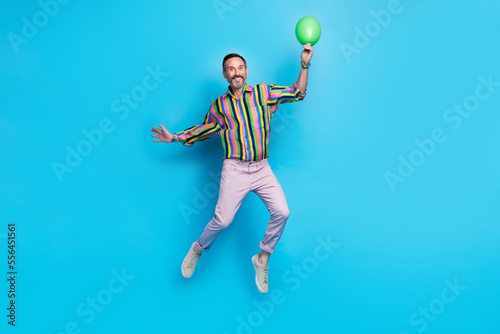 Full length photo of carefree crazy cheerful man rejoice celebrate new year professional career growth isolated on blue color background