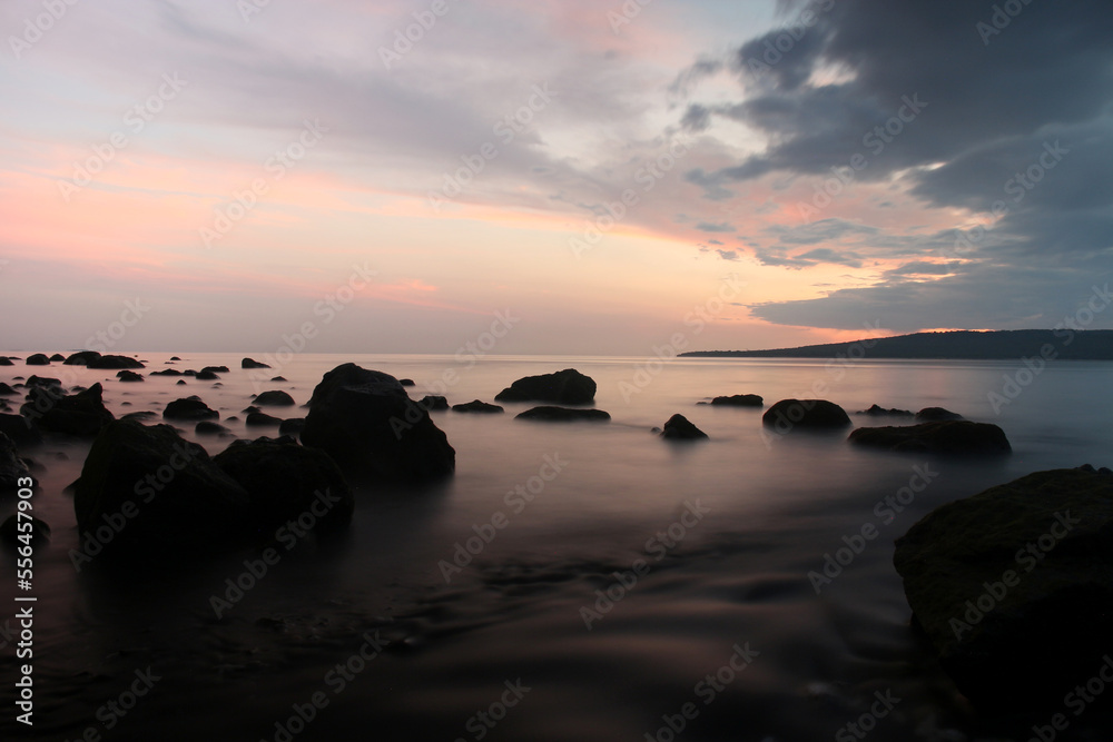 a beachside rock, with a beautiful view, taken at low speed