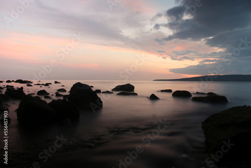 a beachside rock, with a beautiful view, taken at low speed