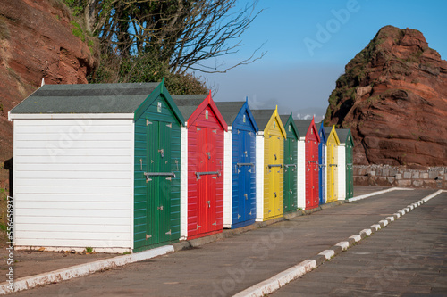 Colourful beach huts at Dawlish coast walk Devon UK with sunny light