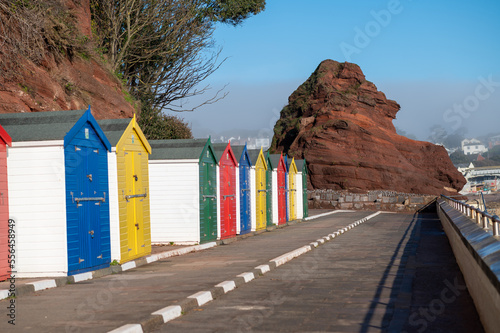 Colourful beach huts at Dawlish coast walk Devon UK with sunny light