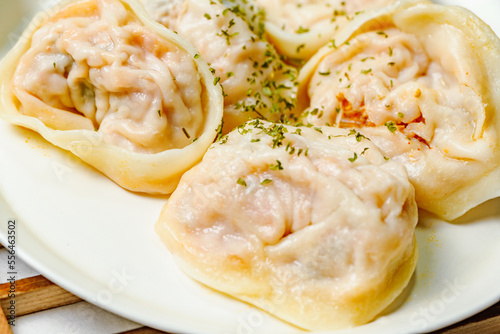 kimchimandu, Korean Kimchi dumpling : Kimchi dumplings are stuffed with a filling of chopped kimchi, bean curd, and vegetables. They are the most popular type of dumpling among Koreans. photo