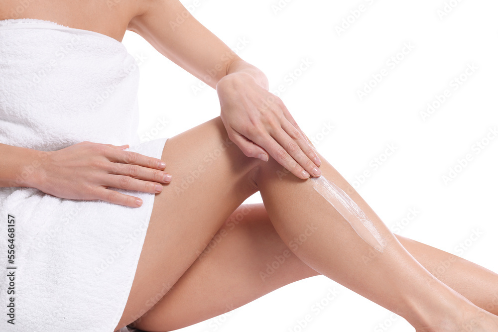 Woman applying body cream onto her leg against white background, closeup Woman applying body cream onto her leg against white background, closeup