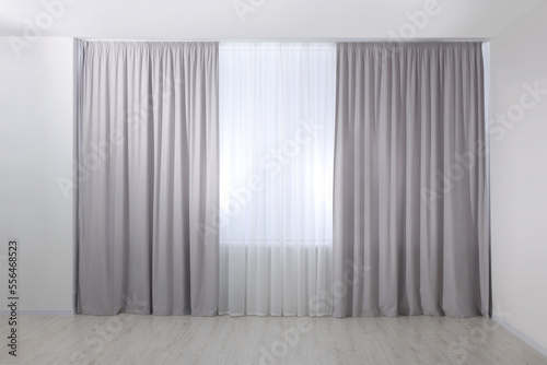 Light grey window curtains and white tulle indoors