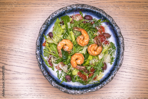 Restaurant dish salad with shrimp and olives