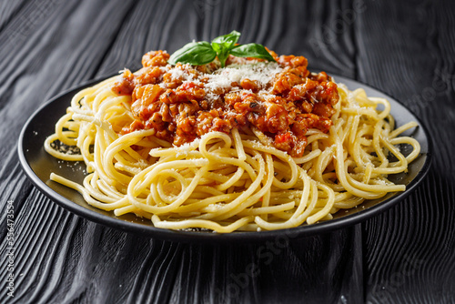 delicious Bolognese pasta on a black plate