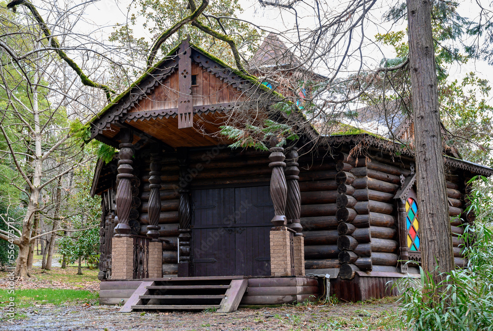 Wooden house with carved columns and platbands in the forest Wooden house with carved columns and platbands in the forest