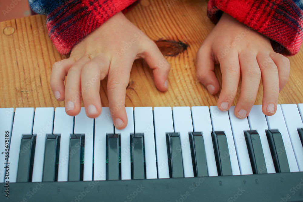learning to play piano in a toy keyboard