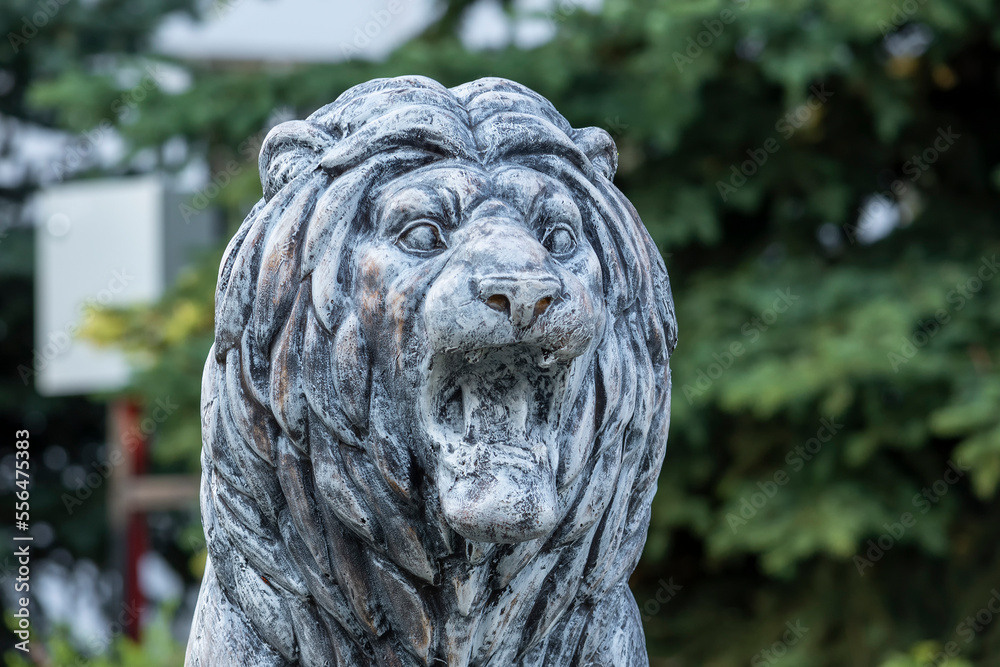 Sculpture of a lion in a park in Russia in the summer.