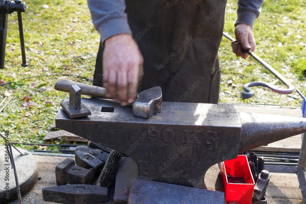 Blacksmith at handwork and glowing coals and iron Blacksmith at handwork and glowing coals and iron
