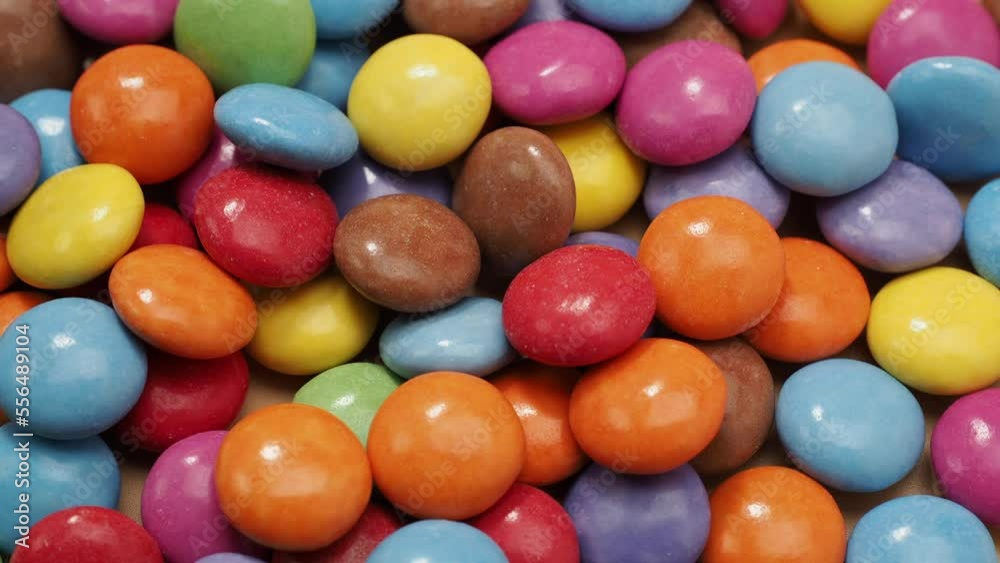 Small multi-colored round candies. Rotating Candies covered with sugar icing. Colored sweetness. Small multi-colored round candies. Rotating Candies covered with sugar icing. Colored sweetness.