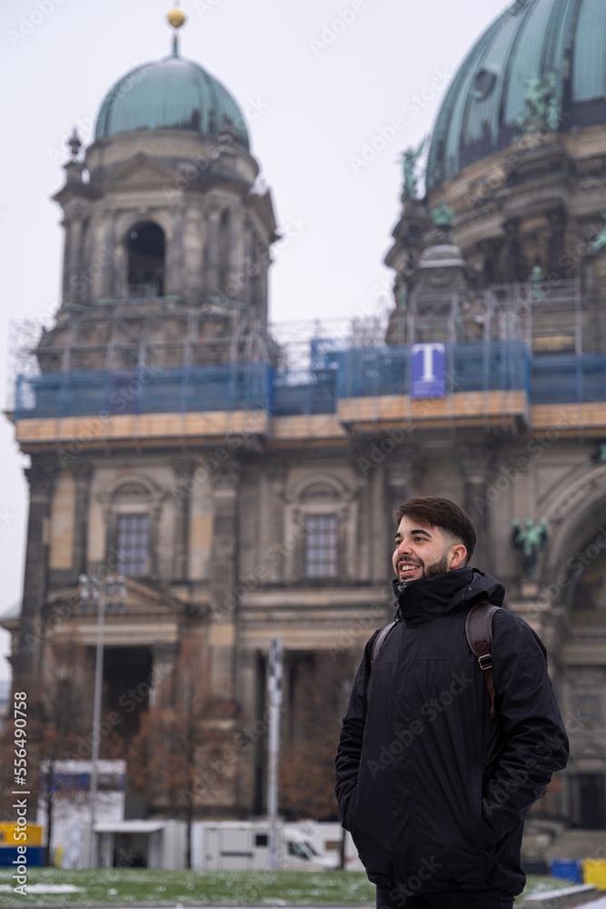 Young male tourist with beard and berlin cathedral in the background