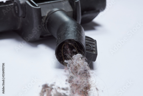 Vacuum cleaner clogged with garbage dirt and hair on a light background Dirt dust hair clogged in the vacuum cleaner tube
