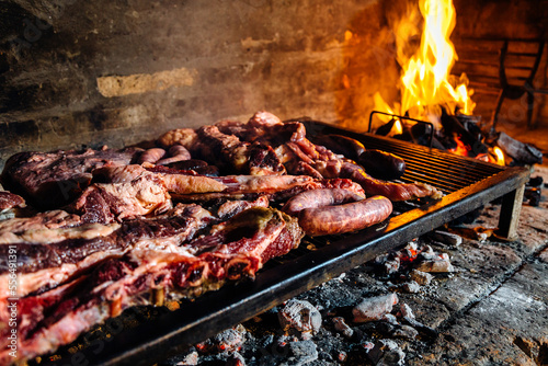 Barbeque, bbq meat cooking on grill. Traditional Asado of Argentina, Paraguay y Uruguay. photo