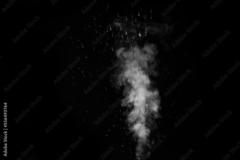 Obraz premium A white curly steam with a spray of drops rising up is isolated on a black background to overlay your photos