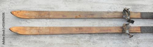 vintage wooden skis on white wooden background