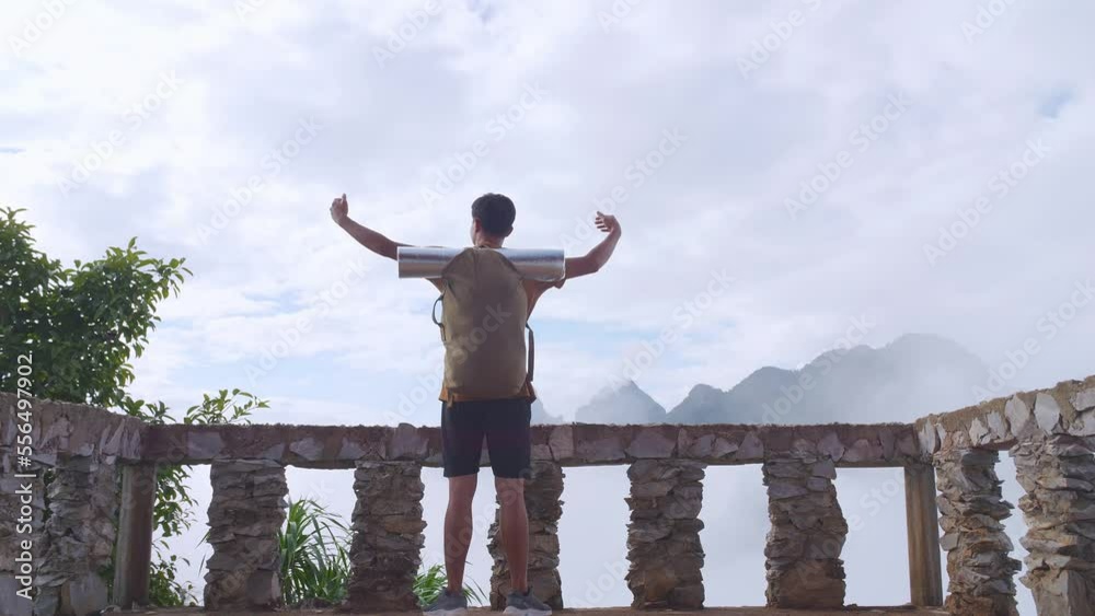 Asian Hiker Male Standing On A Veranda Cliff Enjoys Seeing Beautiful View Of Top Foggy Mountain And Raising His Hands. A Man From The Tent View Of The Mountain
Asian Hiker Male Standing On A Veranda Cliff Enjoys Seeing Beautiful View Of Top Foggy Mountain And Raising His Hands. A Man From The Tent View Of The Mountain