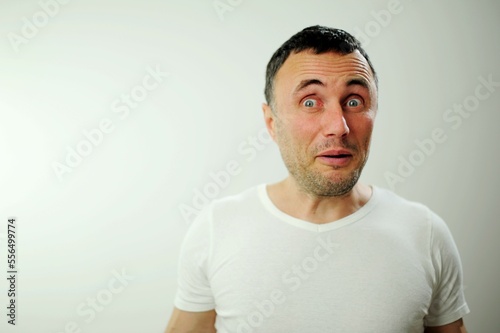 Portrait of man surprised face expression Surprised male hipster, keeps mouth opened, being stupefied as advertises something, Omg concept shouting WOW with copy space fot your text. Shock content