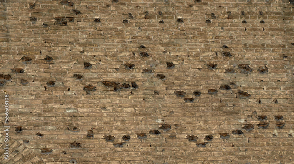 Old brick wall with traces of bullets