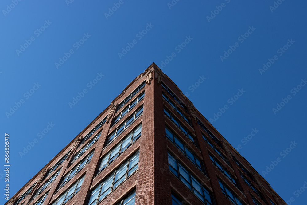 Building symmetry skyward view against natural blue sky gradient. Building symmetry skyward view against natural blue sky gradient.