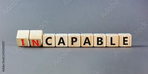Capable or incapable symbol. Concept words Capable or Incapable on wooden cubes. Beautiful grey table grey background. Business capable or incapable concept. Copy space.