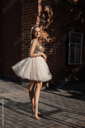 beautiful young slender woman in a light fluffy dress 
