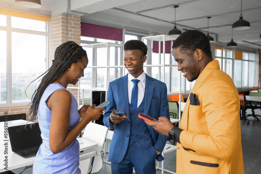 african business people with mobile phones in the office african business people with mobile phones in the office