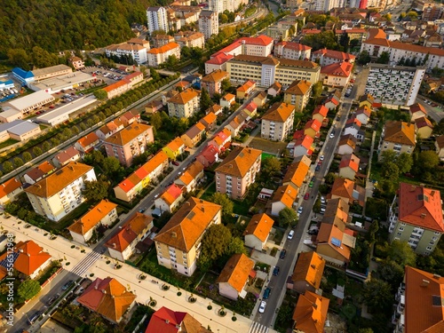  Aerial view of a small city from Romania. Apartment buildings, streets and vegetation is depicted in the picture. Name of city: Resita. 