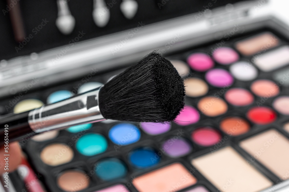 Brush for makeup against palette of eyeshadows. Brush for makeup against palette of eyeshadows.