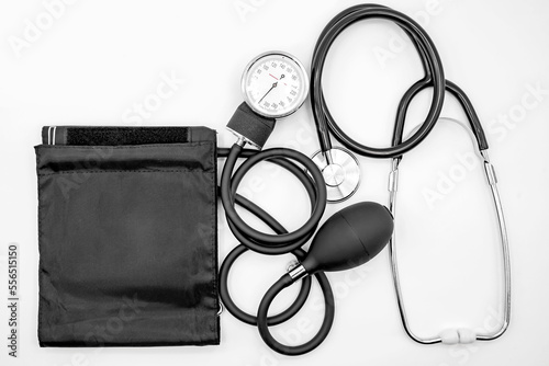 Black blood pressure monitor and stethoscope on a white background close-up