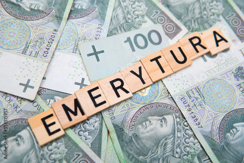 Inscription Emerytura next to polish money. Concept showing retirement in Poland photo