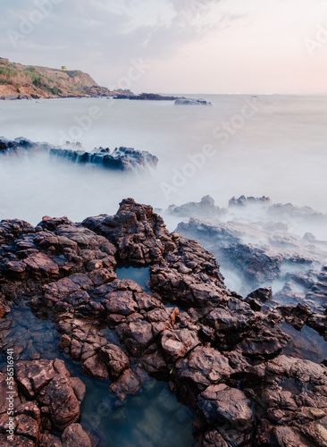 long exposer of rocky coast at sunset photo