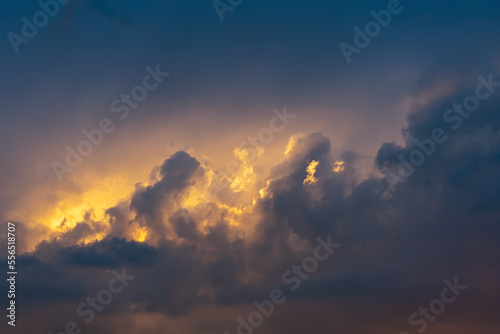 Beautiful storm cumulus clouds in the sky during sunrise or sunset, background © andrei310