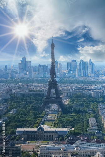 Paris, aerial view of the Eiffel Tower in backlight, sun star, with the Defense towers in background 