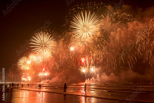 New Year on the beach. Celebrating with exploding colorful fireworks.