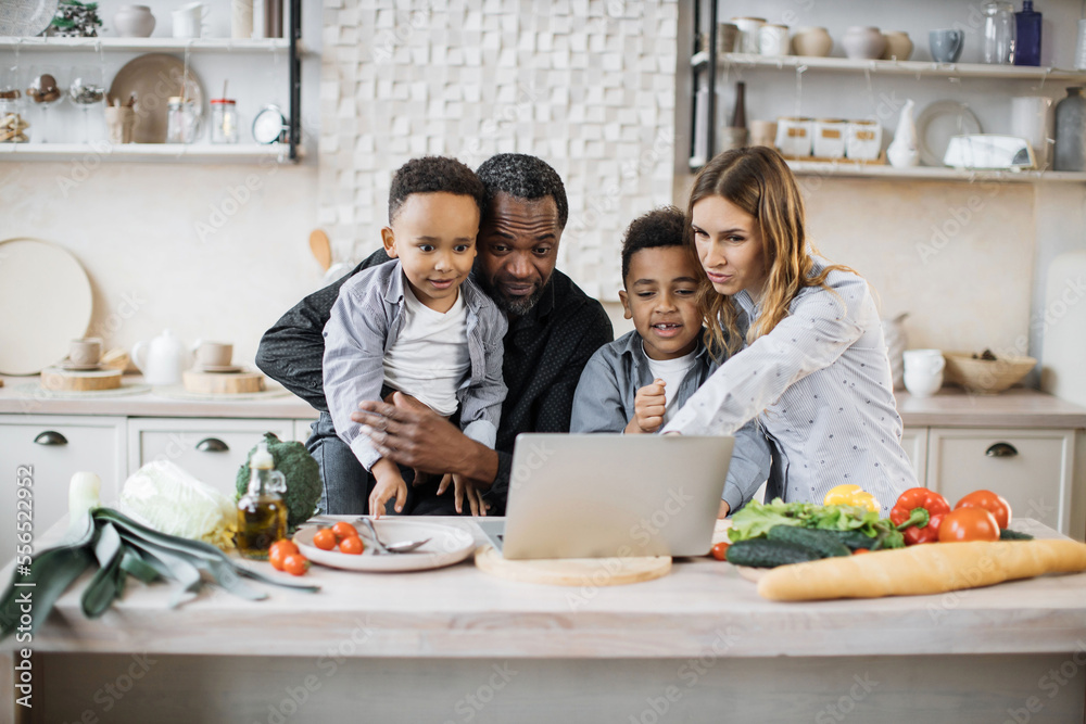 Excited african little boys with their father and caucasian mother