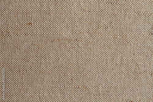 Background - beige rough tarpaulin cloth. Horizontal photo. Closeup. Macro