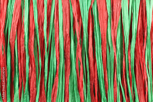 Background - red and green paper raffia strips situated in parallel lines photo