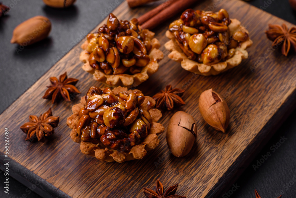 Sweet tasty tart with nuts and honey on a dark concrete background Sweet tasty tart with nuts and honey on a dark concrete background