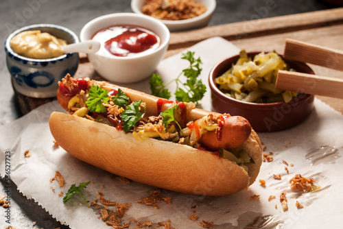 Zwei Hotdogs mit Gurken, Röstzwiebeln, Ketchup und Senf photo