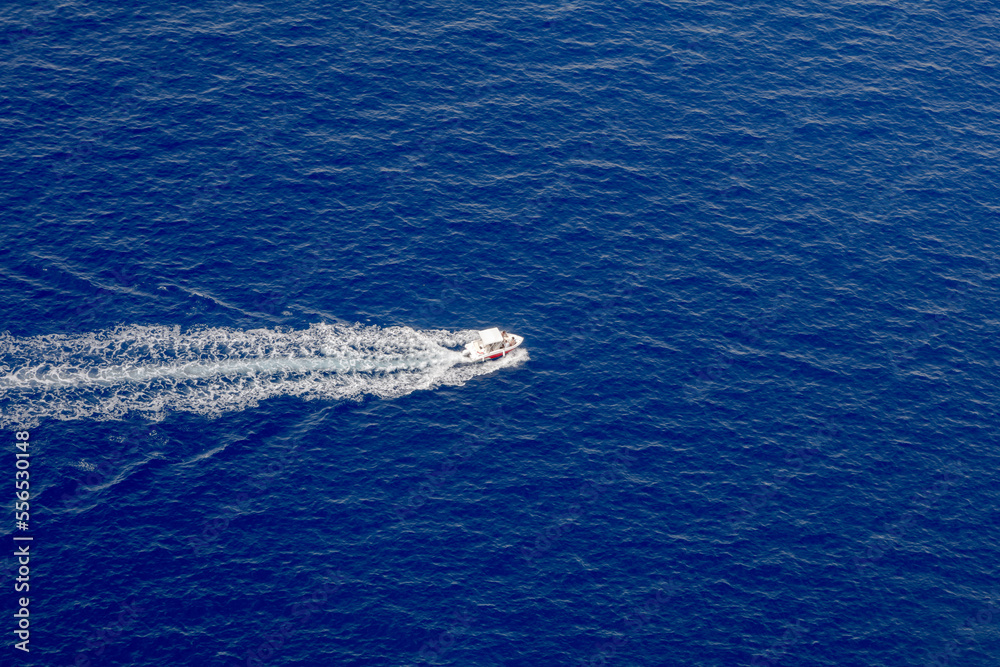 Small ship with track water foam on ocean Small ship with track water foam on ocean