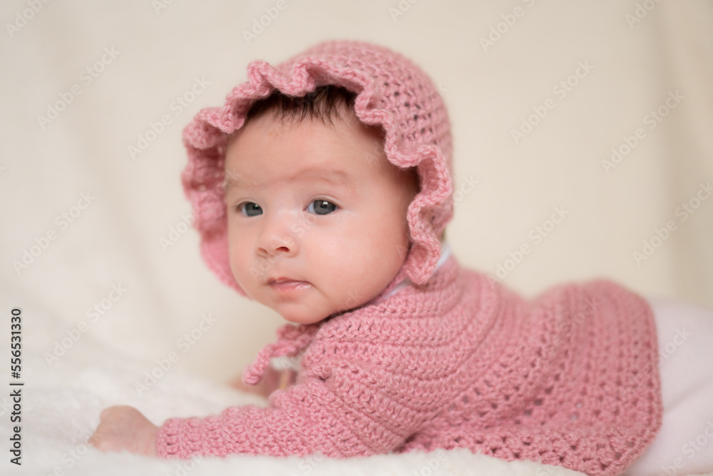 beautiful portrait of adorable mixed ethnicity Asian Caucasian baby girl a few weeks old lying on white blanket wearing a sweet pink hat in new life and newborn concept beautiful portrait of adorable mixed ethnicity Asian Caucasian baby girl a few weeks old lying on white blanket wearing a sweet pink hat in new life and newborn concept