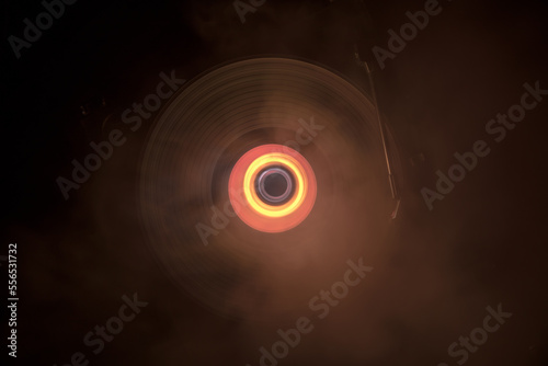 Music Dj concept. Trail of fire and smoke on vinyl record. Burning vinyl disk. Turntable vinyl record play Selective focus
