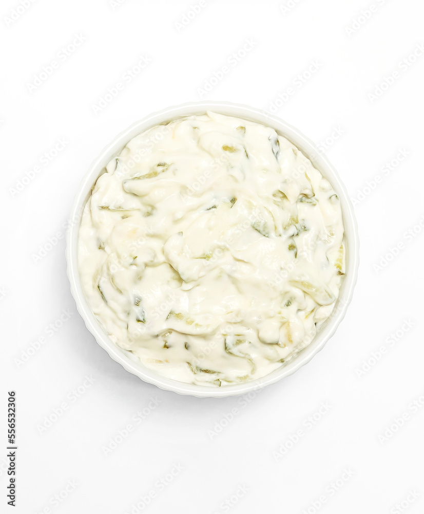 Isolated traditional greek yogurt sauce Tzatziki,dressing in white bowl, made of grated cucumbers, sour cream yogurt,olive oil,garlic,herbs on white background. Close up, flatly, vertical Isolated traditional greek yogurt sauce Tzatziki,dressing in white bowl, made of grated cucumbers, sour cream yogurt,olive oil,garlic,herbs on white background. Close up, flatly, vertical
