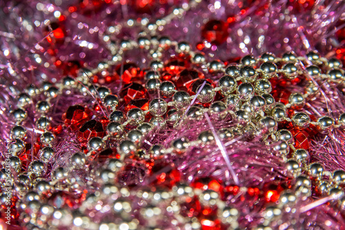 White and red beads on a shiny garland. Christmas mood and decoration with shiny light. Loop animation. 