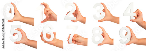 Children's hands hold numbers. A set of white numbers in hands on a black isolated background. Zero, one, two, three, four, five, six, seven, eight, nine