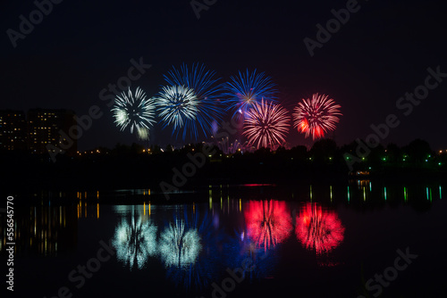Beautiful blue and red fireworks with reflection in the pond