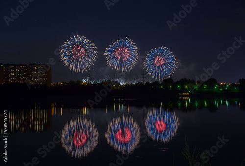 Beautiful blue and red fireworks with reflection in the pond