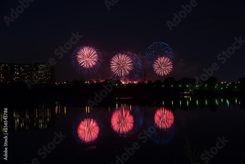 Beautiful blue and red fireworks with reflection in the pond
